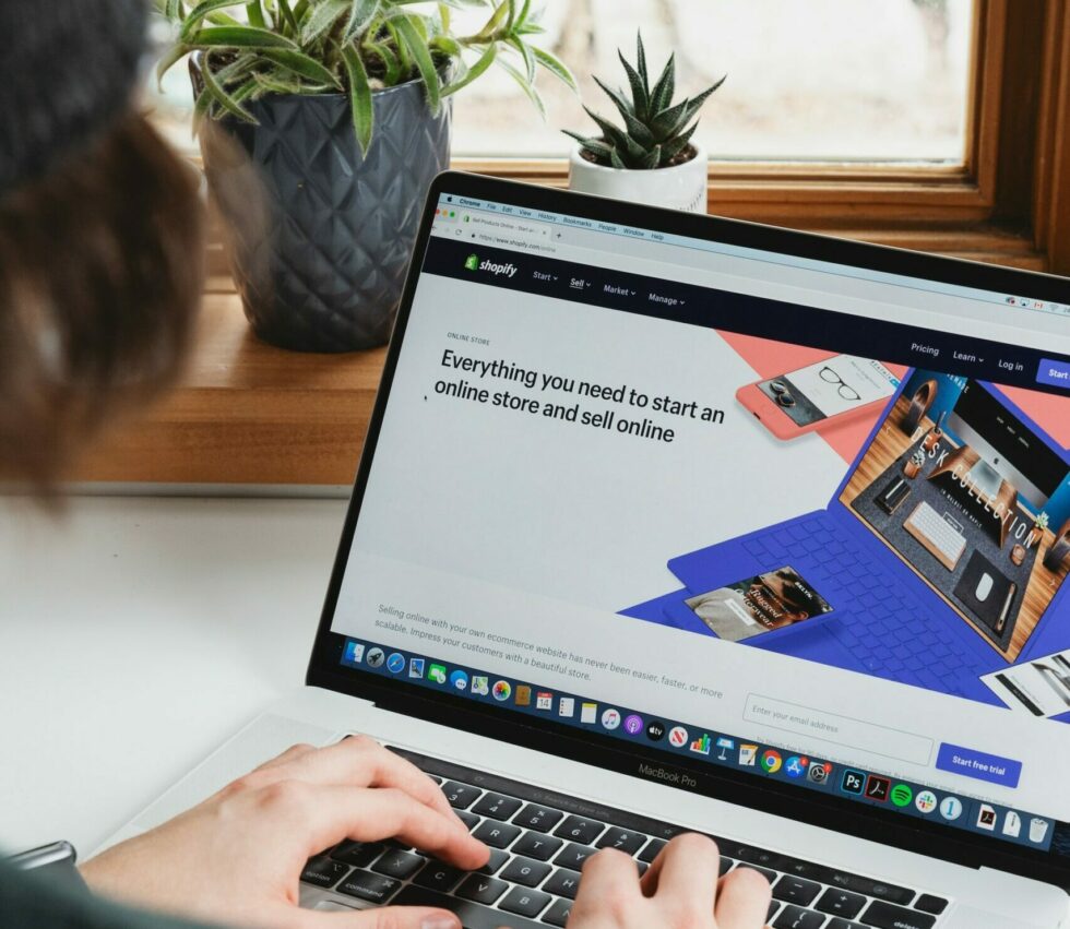 Man on a laptop with shopify on the screen